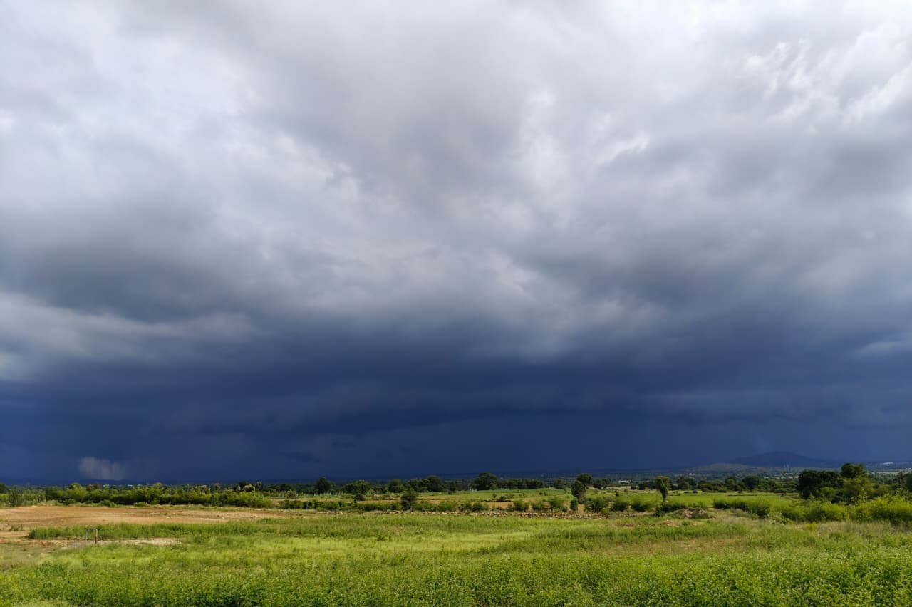 Actual Wisdom property landscape beneath dramatic storm clouds